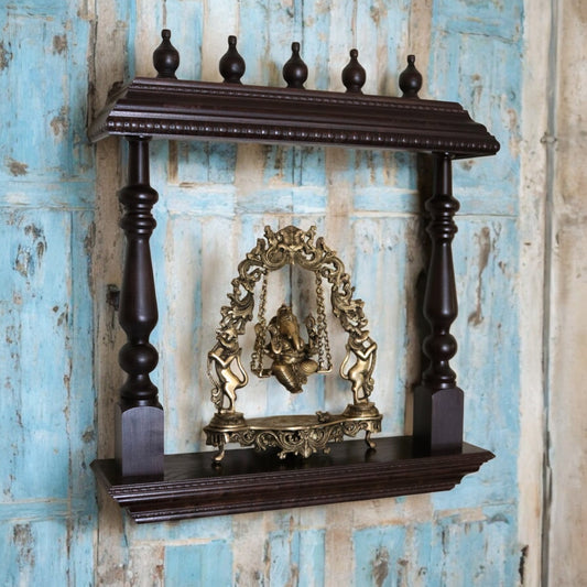 Handcrafted wooden wall shelf with intricate carvings and Ganesha idol, perfect for home temple decor