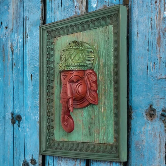 Hand-carved wooden Ganesha wall decor in green and red, rustic antique style, measuring 14 inches in height, ideal for spiritual or home decor.