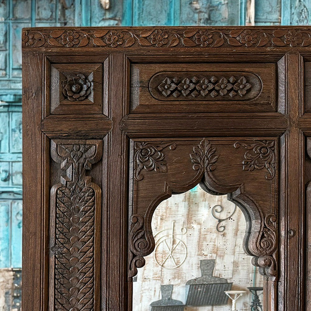 Traditional Indian Jharokha mirror with rustic gold accents.