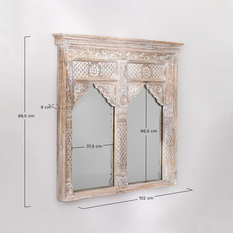 Whitewashed carved mirror with traditional Indian design, perfect for retro wall art or a focal point in a rustic home setting.